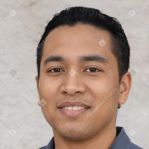 Joyful latino young-adult male with short  black hair and brown eyes