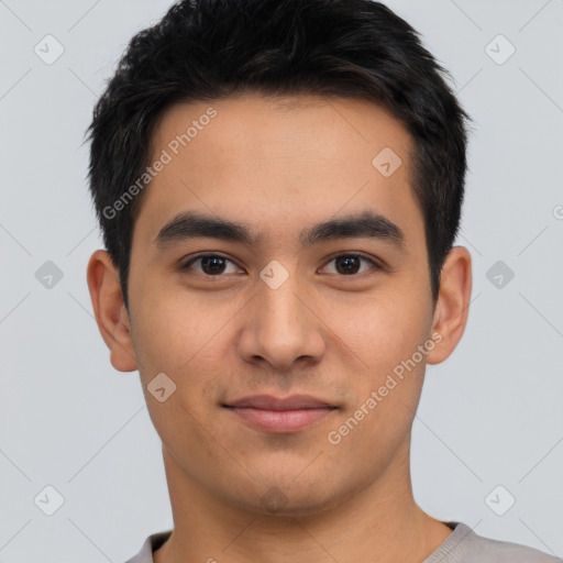 Joyful asian young-adult male with short  brown hair and brown eyes