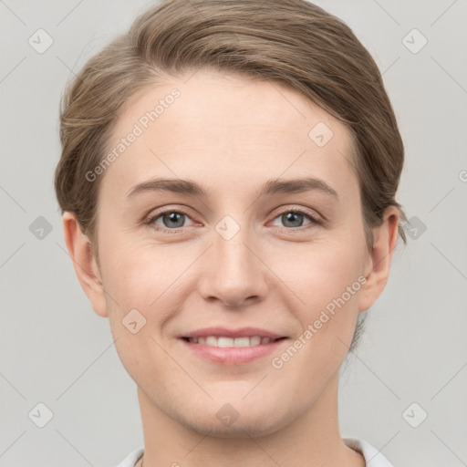 Joyful white young-adult female with short  brown hair and grey eyes