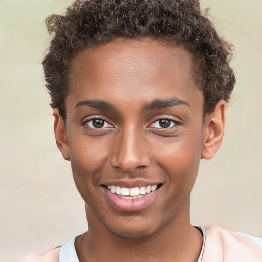 Joyful black young-adult male with short  brown hair and brown eyes