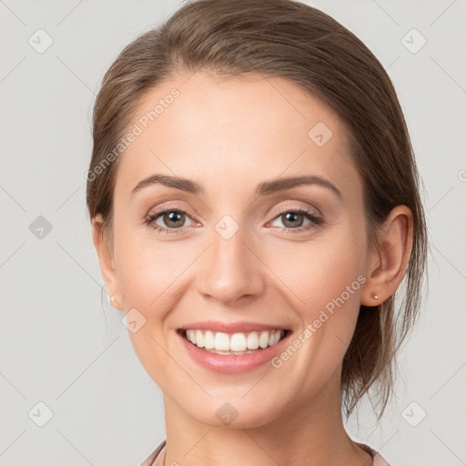 Joyful white young-adult female with medium  brown hair and grey eyes