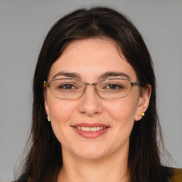 Joyful white adult female with medium  brown hair and brown eyes