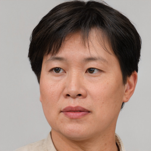 Joyful asian adult female with short  brown hair and brown eyes