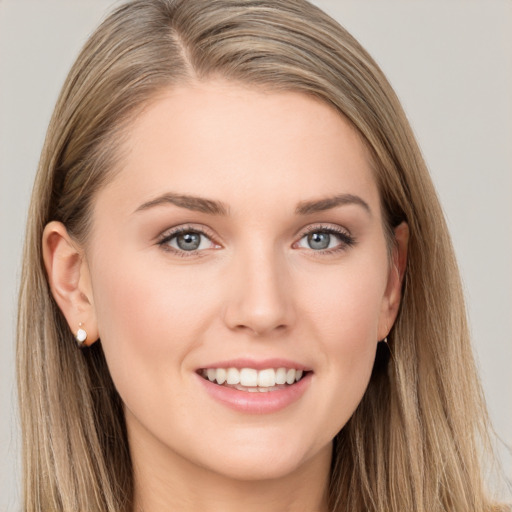 Joyful white young-adult female with long  brown hair and grey eyes