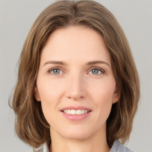 Joyful white young-adult female with medium  brown hair and green eyes