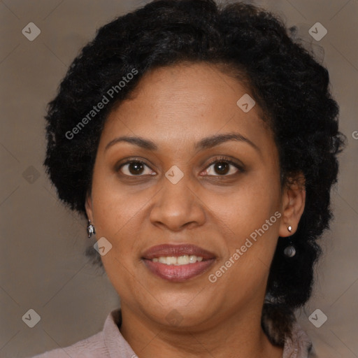 Joyful black adult female with medium  brown hair and brown eyes