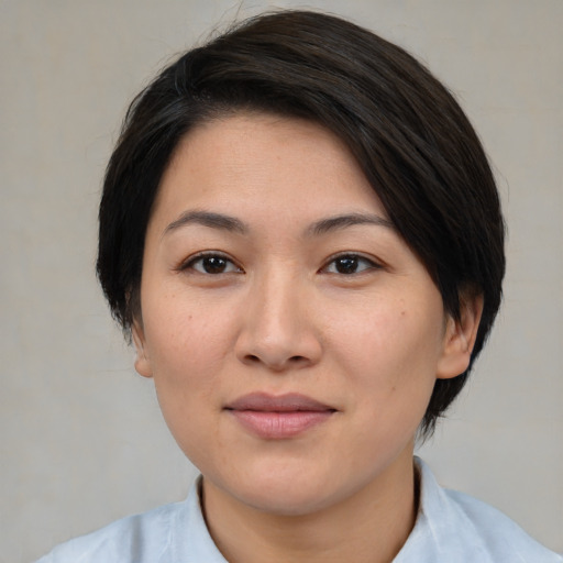 Joyful white young-adult female with medium  black hair and brown eyes