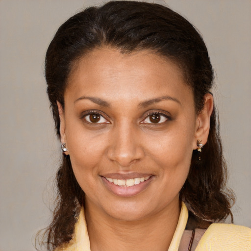 Joyful black young-adult female with medium  brown hair and brown eyes