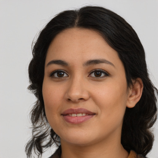 Joyful latino young-adult female with long  brown hair and brown eyes