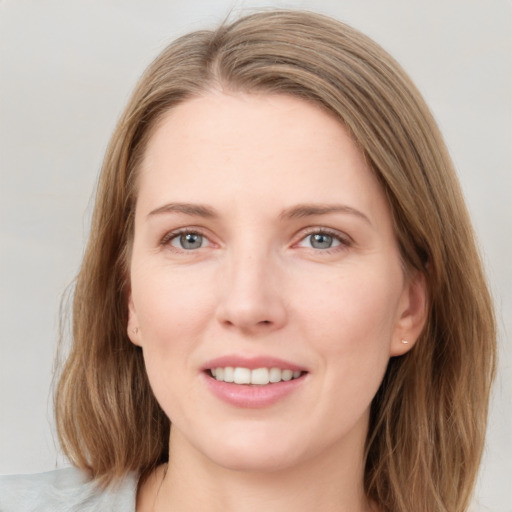 Joyful white young-adult female with medium  brown hair and blue eyes