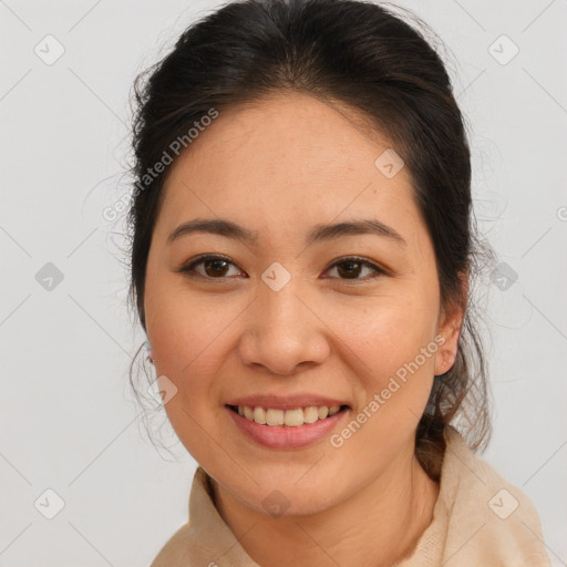 Joyful latino young-adult female with medium  brown hair and brown eyes