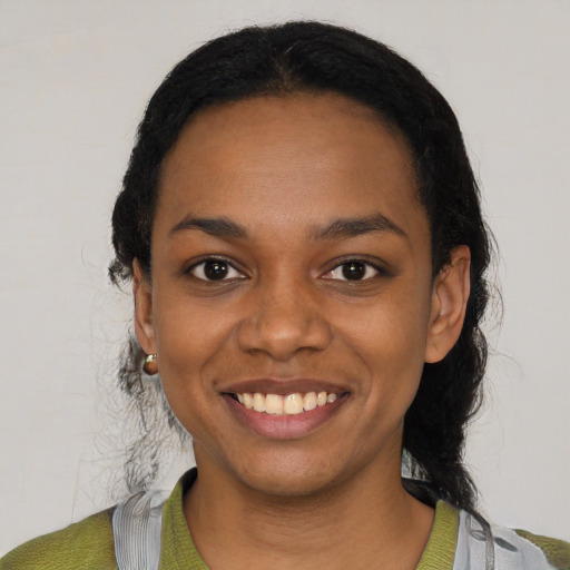 Joyful black young-adult female with short  black hair and brown eyes