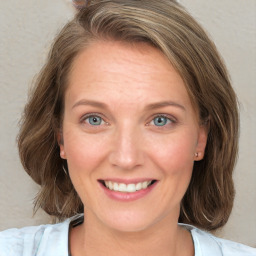 Joyful white young-adult female with medium  brown hair and blue eyes