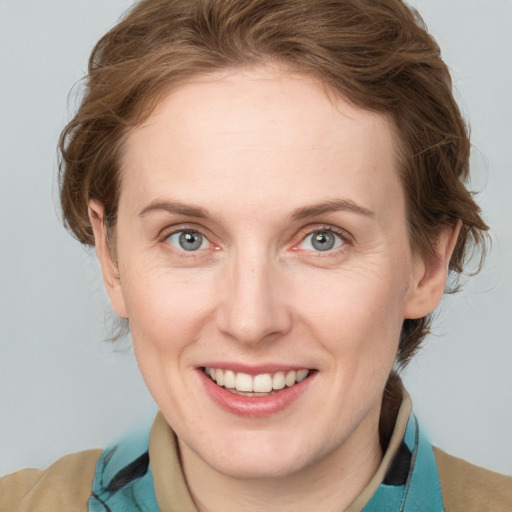 Joyful white adult female with medium  brown hair and blue eyes