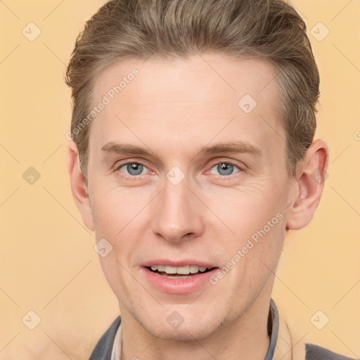 Joyful white adult male with short  brown hair and grey eyes