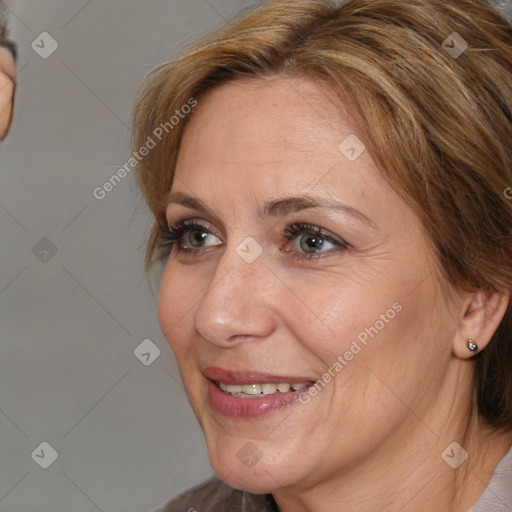 Joyful white adult female with medium  brown hair and brown eyes