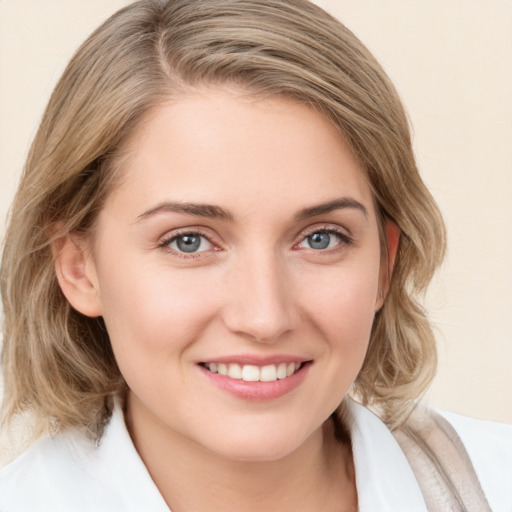 Joyful white young-adult female with medium  brown hair and blue eyes