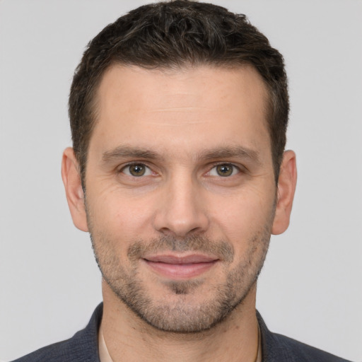 Joyful white young-adult male with short  brown hair and brown eyes