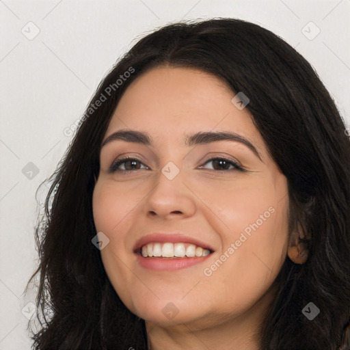 Joyful white young-adult female with long  black hair and brown eyes