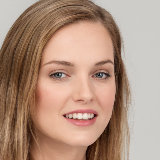 Joyful white young-adult female with long  brown hair and green eyes