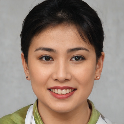 Joyful latino young-adult female with short  brown hair and brown eyes