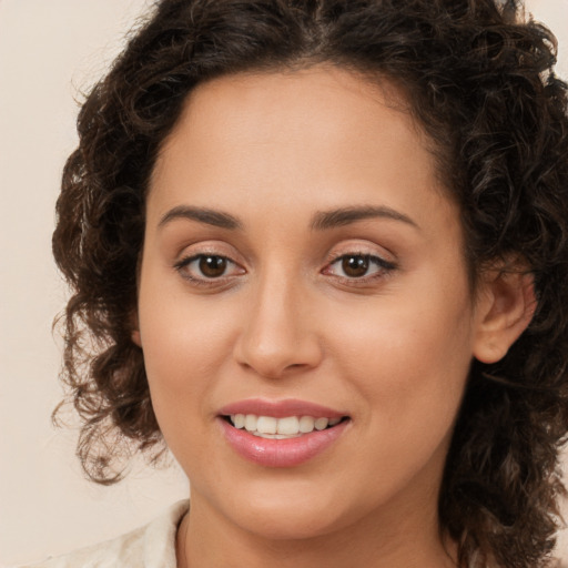 Joyful white young-adult female with long  brown hair and brown eyes