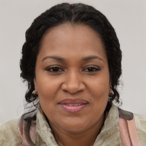 Joyful black adult female with long  brown hair and brown eyes