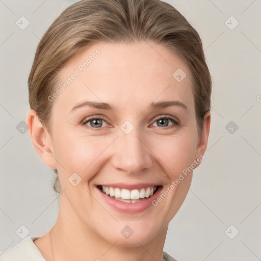 Joyful white young-adult female with short  brown hair and grey eyes