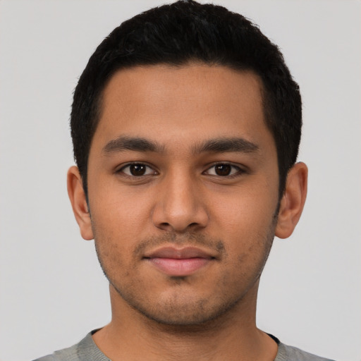 Neutral latino young-adult male with short  black hair and brown eyes