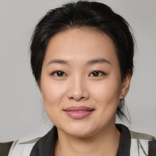 Joyful asian young-adult female with medium  brown hair and brown eyes