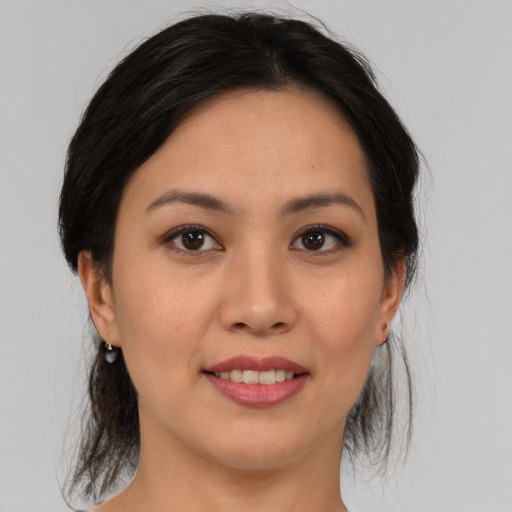 Joyful asian young-adult female with medium  brown hair and brown eyes