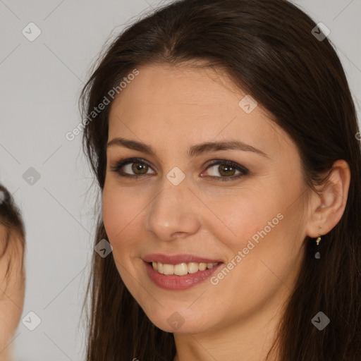 Joyful white young-adult female with long  brown hair and brown eyes