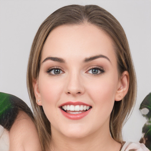 Joyful white young-adult female with medium  brown hair and green eyes