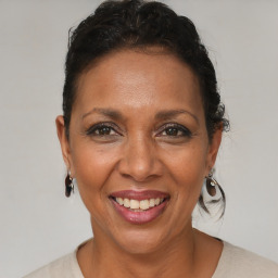 Joyful black adult female with short  brown hair and brown eyes