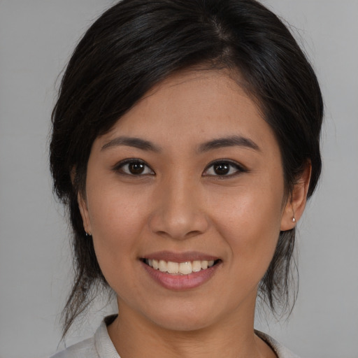 Joyful asian young-adult female with medium  brown hair and brown eyes