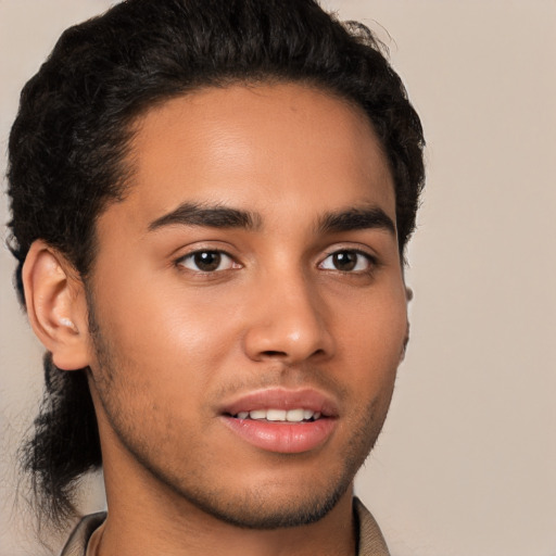 Joyful latino young-adult male with short  brown hair and brown eyes