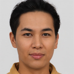 Joyful asian young-adult male with short  brown hair and brown eyes