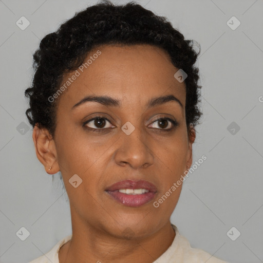 Joyful black young-adult female with short  brown hair and brown eyes