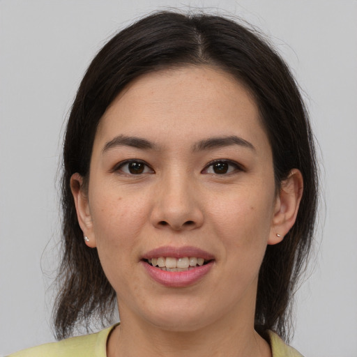 Joyful latino young-adult female with medium  brown hair and brown eyes