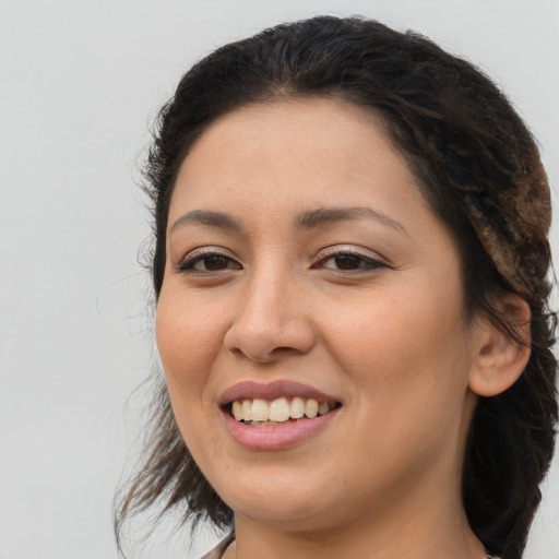 Joyful latino young-adult female with long  brown hair and brown eyes