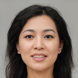 Joyful asian young-adult female with long  brown hair and brown eyes