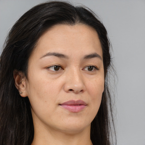 Joyful asian young-adult female with long  brown hair and brown eyes