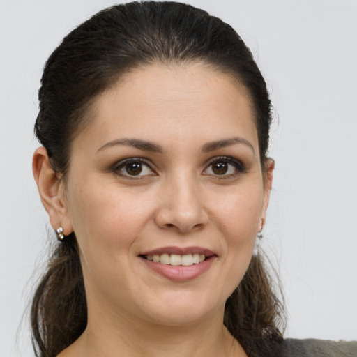 Joyful white young-adult female with medium  brown hair and brown eyes