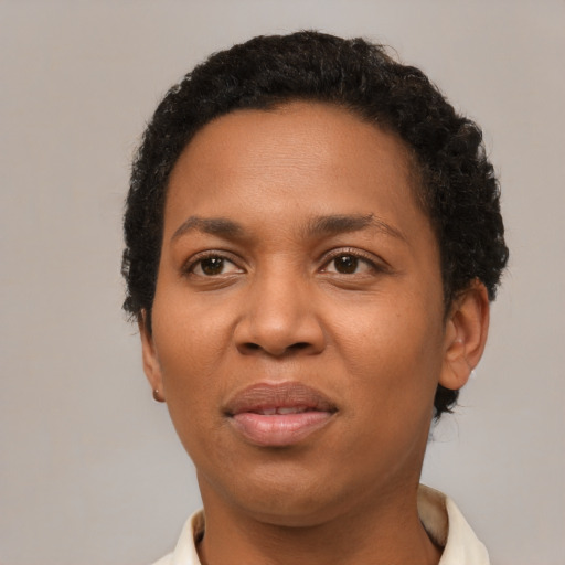 Joyful black adult female with short  black hair and brown eyes
