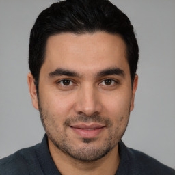 Joyful white young-adult male with short  black hair and brown eyes