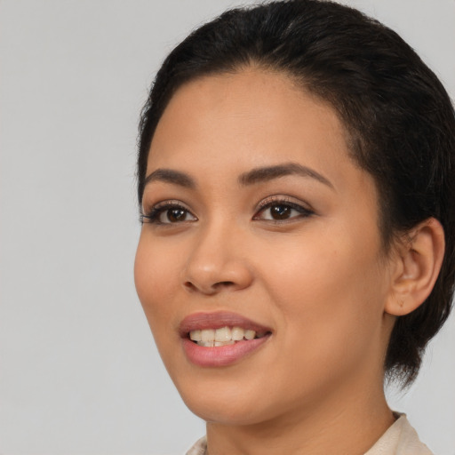 Joyful latino young-adult female with medium  black hair and brown eyes