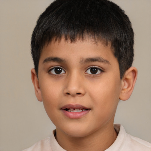 Joyful latino child male with short  brown hair and brown eyes