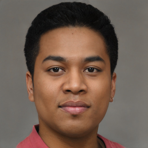 Joyful black young-adult male with short  black hair and brown eyes