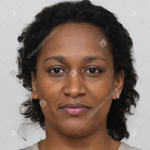 Joyful black adult female with short  brown hair and brown eyes