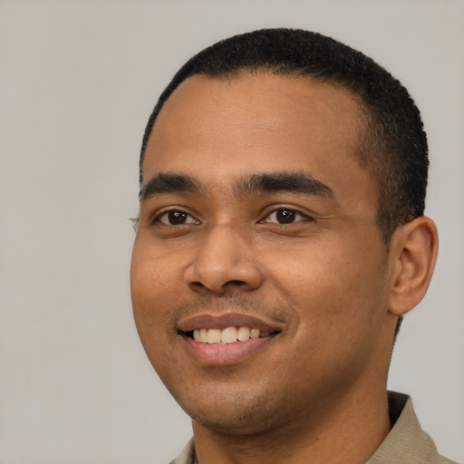 Joyful latino young-adult male with short  black hair and brown eyes